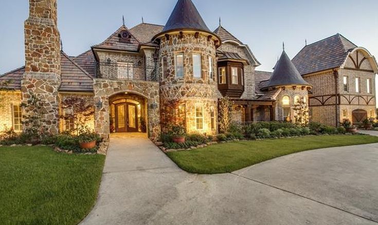 a large brick and stone house in the evening