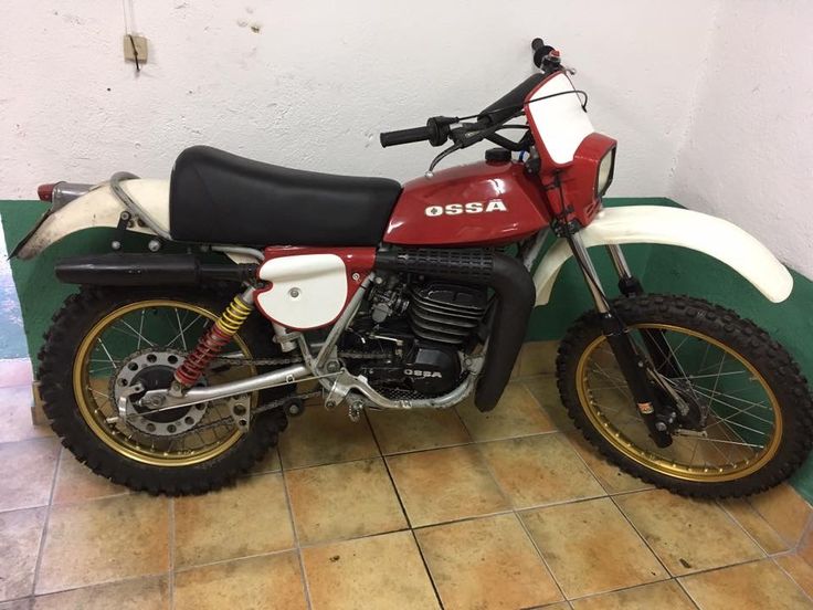 a red and white dirt bike parked in a room