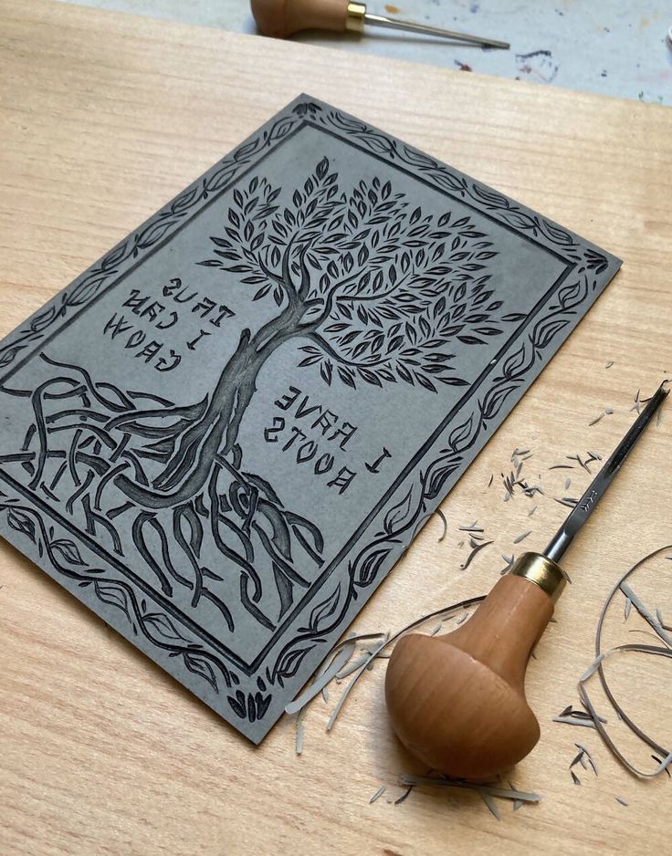 a wooden table topped with a book next to a pair of scissors