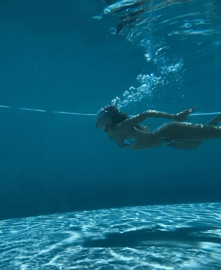 a woman is swimming in the water