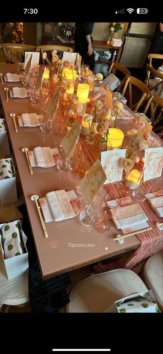 a long table is set with place settings and napkins for guests to sit at