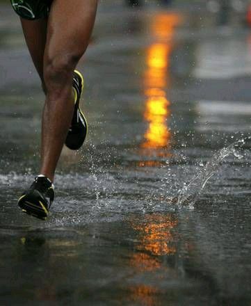 a person running in the rain with their shoes on