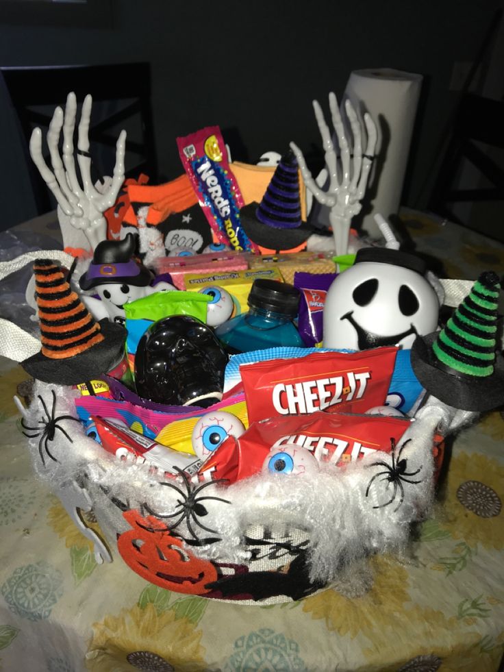 a table topped with lots of halloween decorations and candy bags on top of it's head