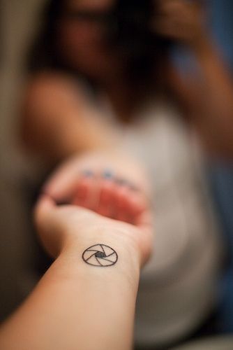 a person with a small tattoo on their arm