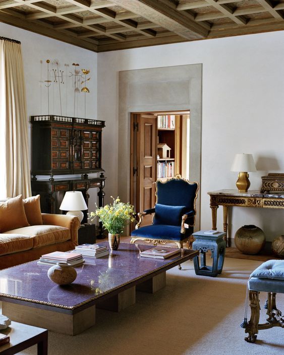 a living room with couches, chairs and a table in front of a window