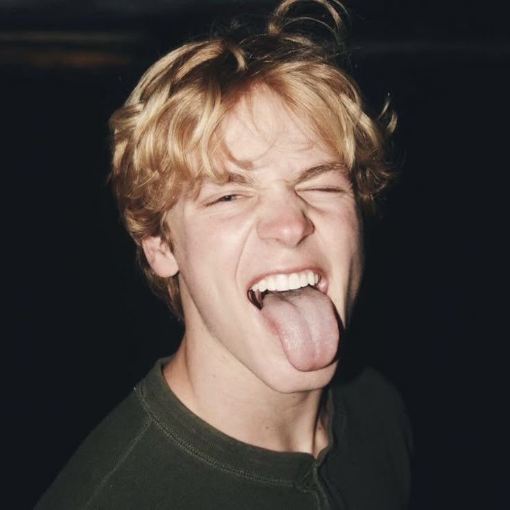 a young man making a funny face with his tongue out