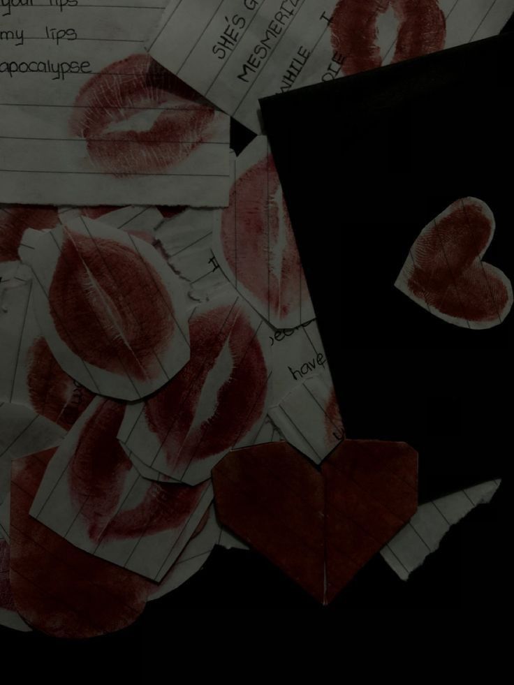 a pile of paper with red hearts on it