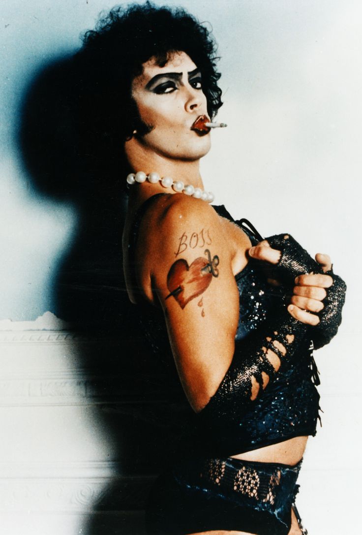 a woman with black makeup and tattoos on her body