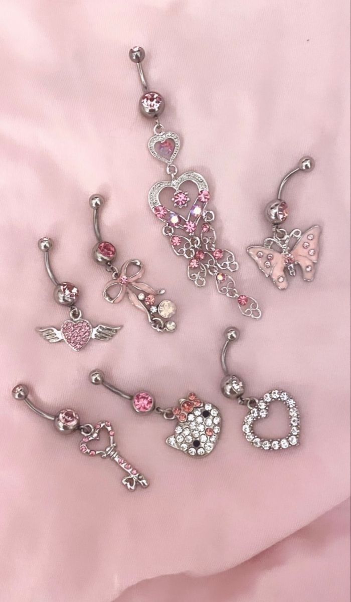 several different types of piercings on a pink sheet