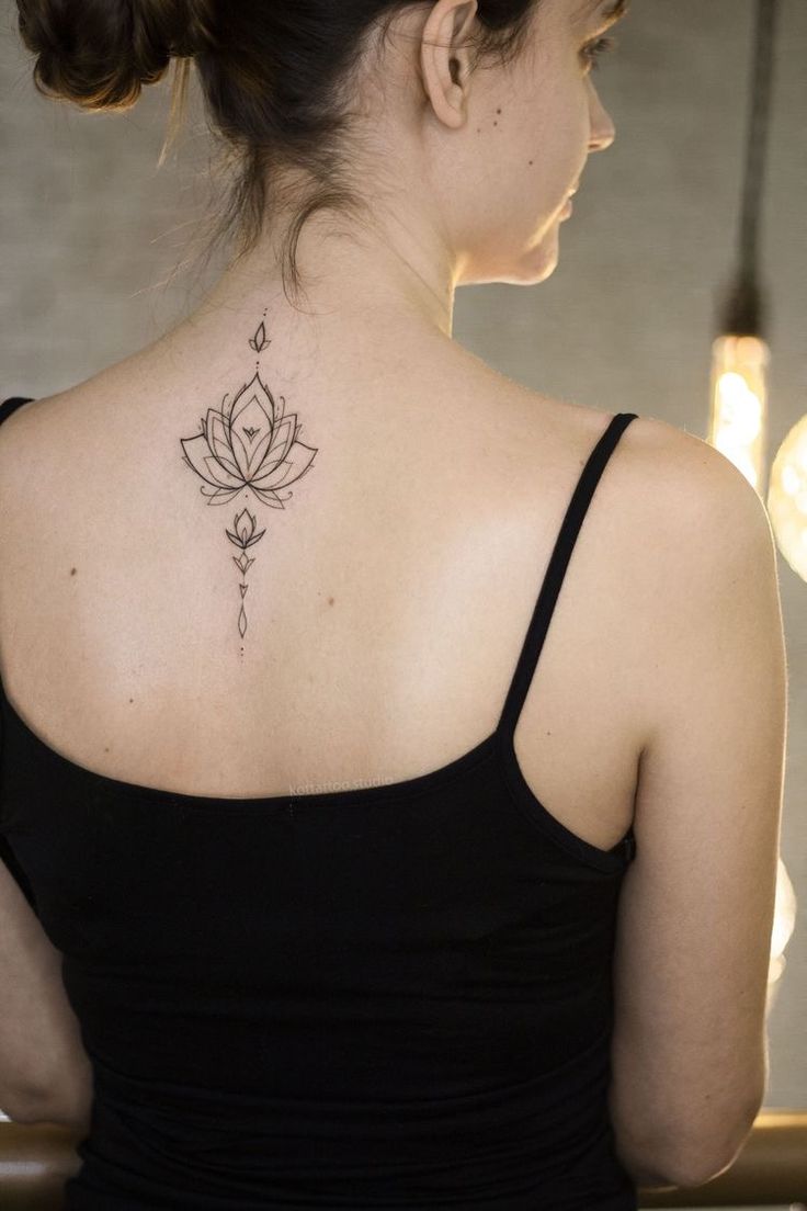 a woman with a lotus tattoo on her back