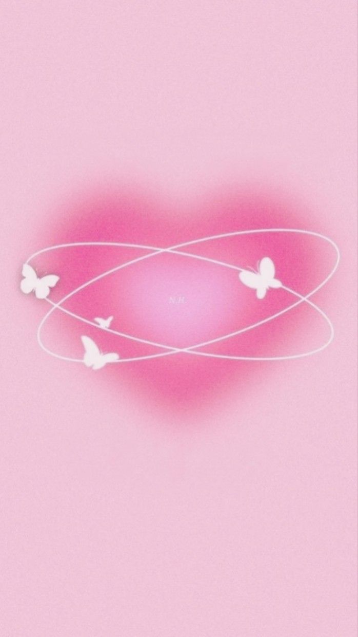 three white butterflies flying around a pink heart