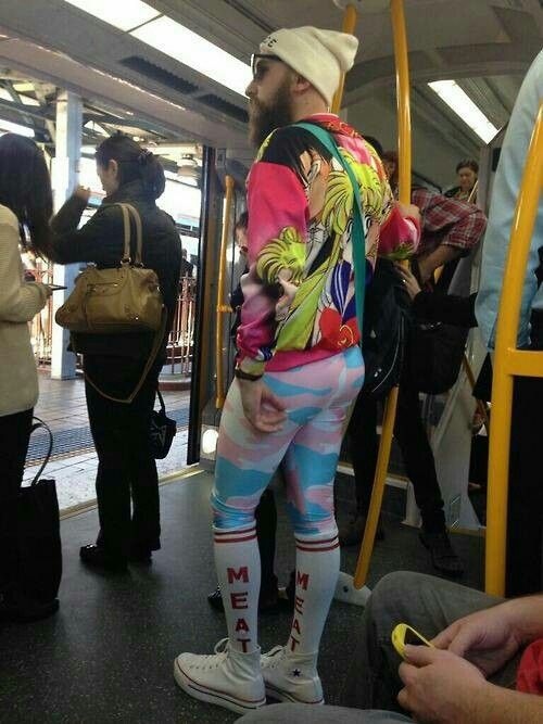 a man in colorful clothing standing on a bus