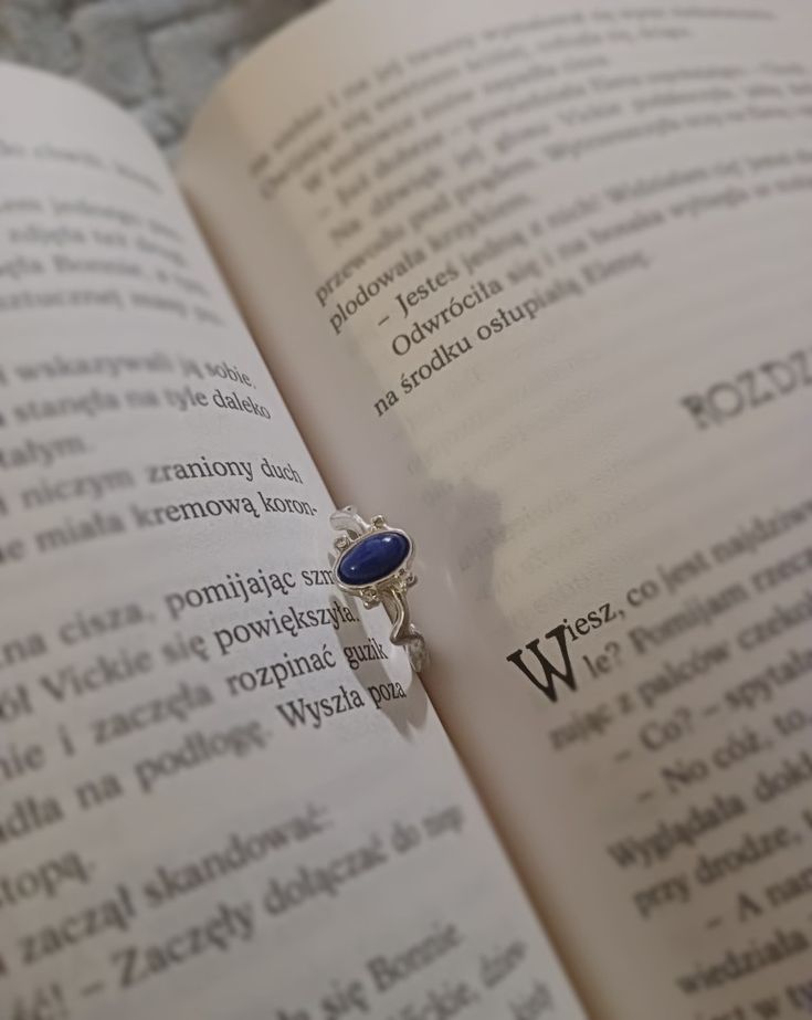 a ring sitting on top of an open book