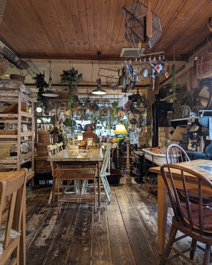 a room filled with lots of wooden tables and chairs