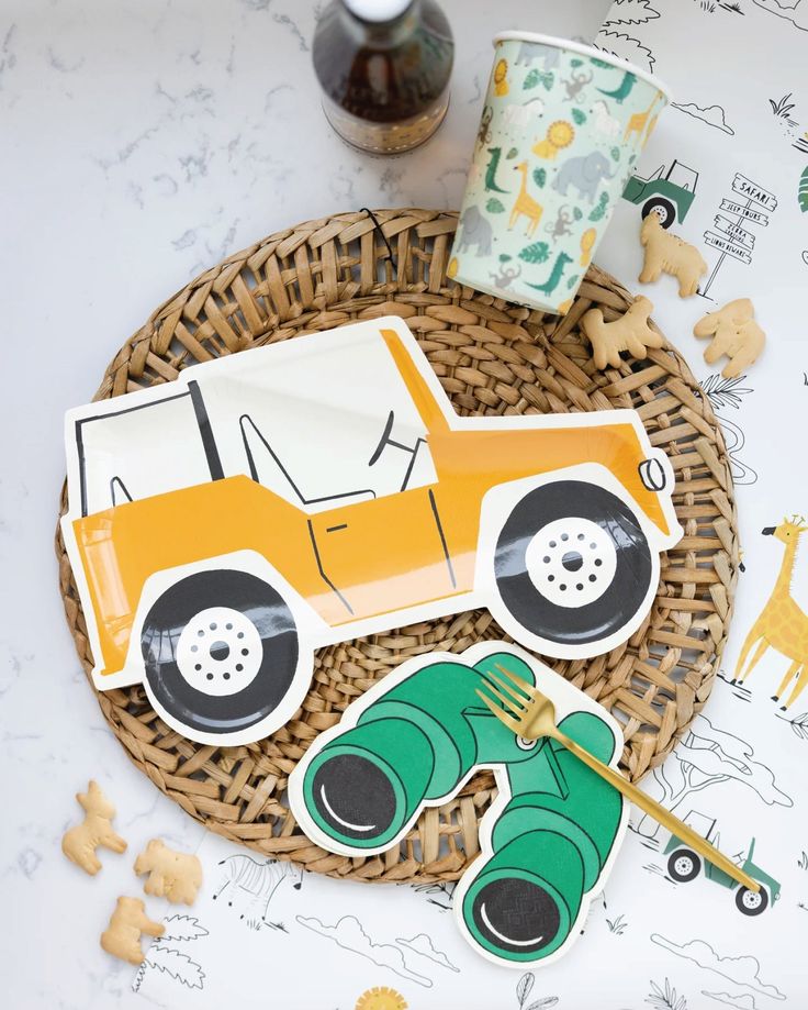 an image of a paper cut out of a car on a table with other items