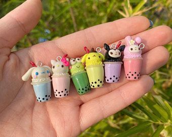 small toy animals are sitting in the palm of someone's hand