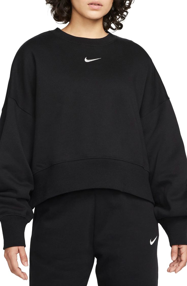 An embroidered Swoosh adds minimal branding to this cozy fleece sweatshirt cut for a relaxed, oversized fit that's enhanced by the dropped shoulders. 22" length (size Medium) Crewneck 80% cotton, 20% polyester Machine wash, tumble dry Imported Nike Phoenix Fleece, Nike Crew Neck, Nike Sportswear Women, Gym Attire, Women's Sportswear, Nike Fleece, Oversized Crewneck, Cut Sweatshirts, Nike Sweater