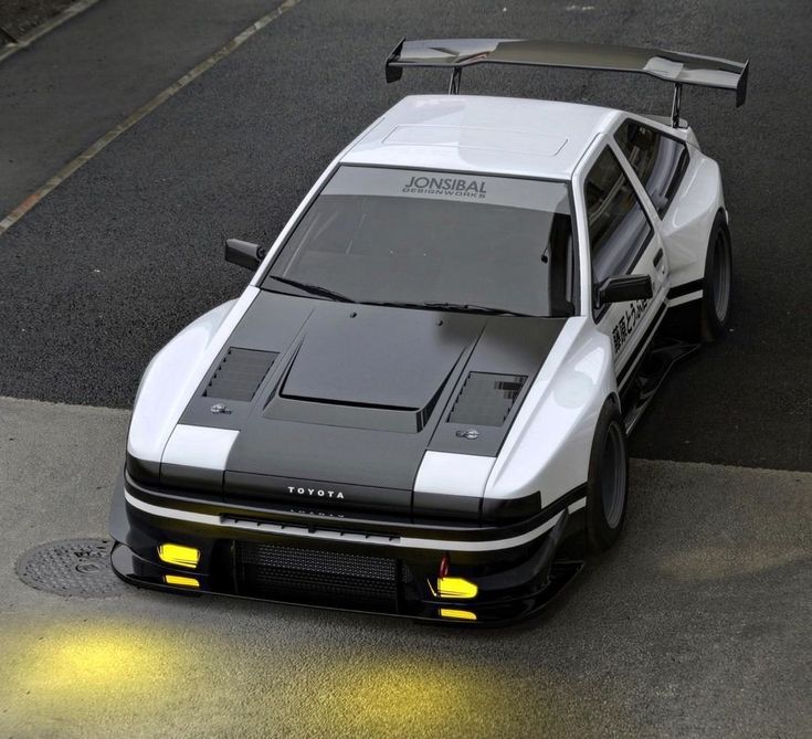 a white and black sports car parked on the street