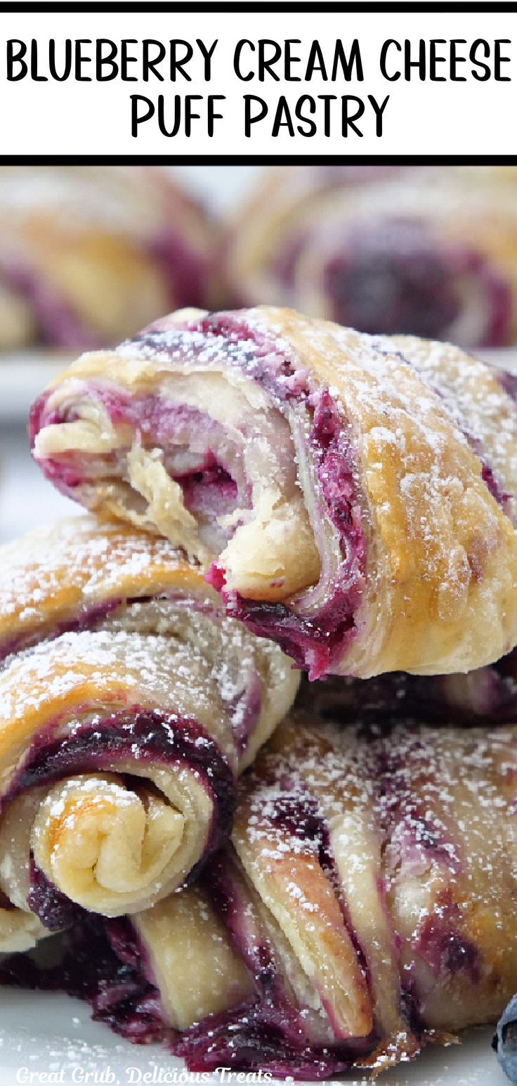 Three blueberry puff pastries dusted with powdered sugar on a plate with a bite taken out of the top one. Blueberry Cream Cheese Puff Pastry, Braided Puff Pastry, Blueberry Puff Pastry, Pastry Recipes Dessert, Cream Cheese Puffs, Easy Puff Pastry Recipe, Cream Cheese Puff Pastry, Pastry Dough Recipe, Puff Pastry Recipes Dessert