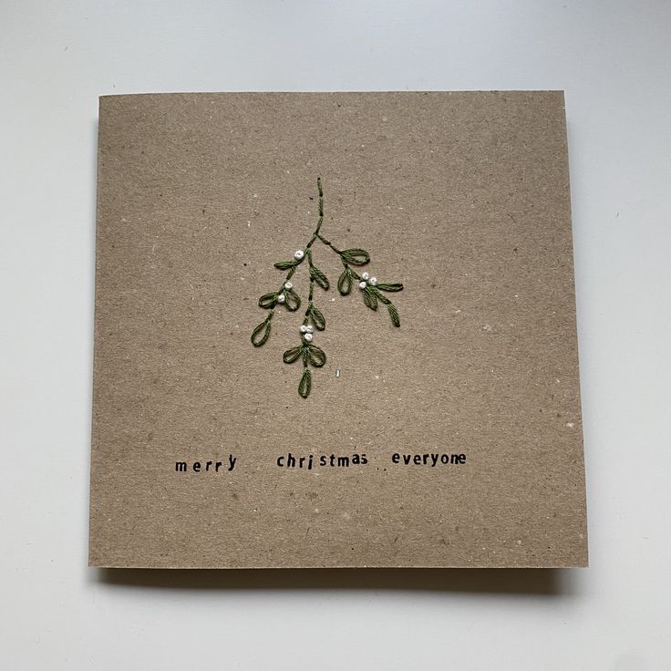 a card with an olive branch and merry christmas everyone written on it