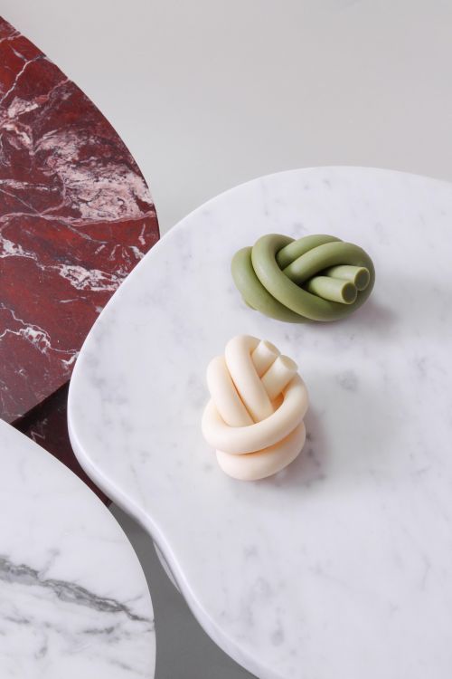 two pieces of food sitting on top of a white marble table next to each other