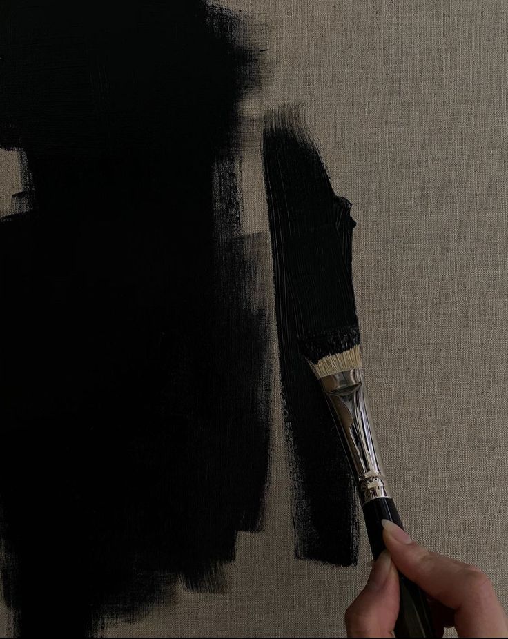 a person holding a paint brush in their hand