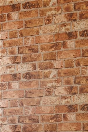 a red brick wall with a clock on it