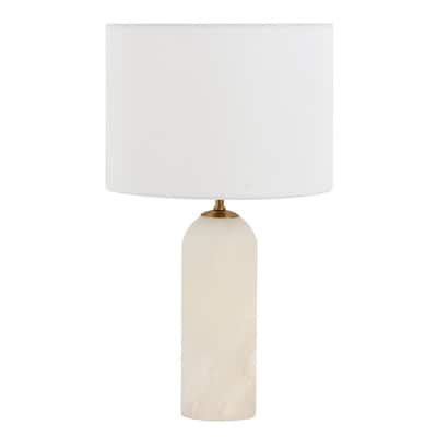 a table lamp with a white shade on the base and a light bulb in front of it