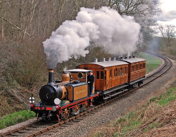 an old fashioned steam train traveling down the tracks