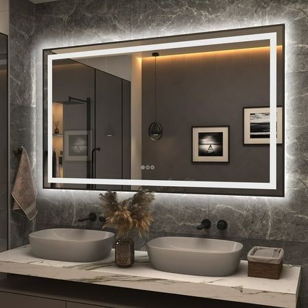 a bathroom with two sinks and a large mirror above it's counter top area