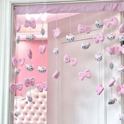 a pink room with hello kitty decorations hanging from the ceiling