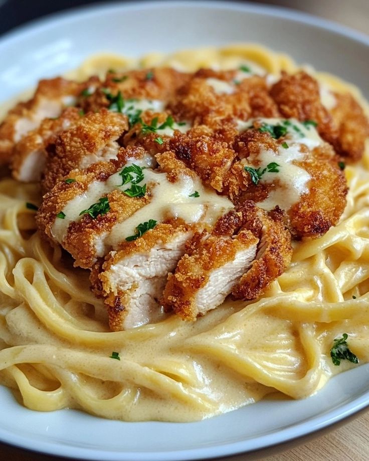 pasta with chicken and parmesan cheese on top