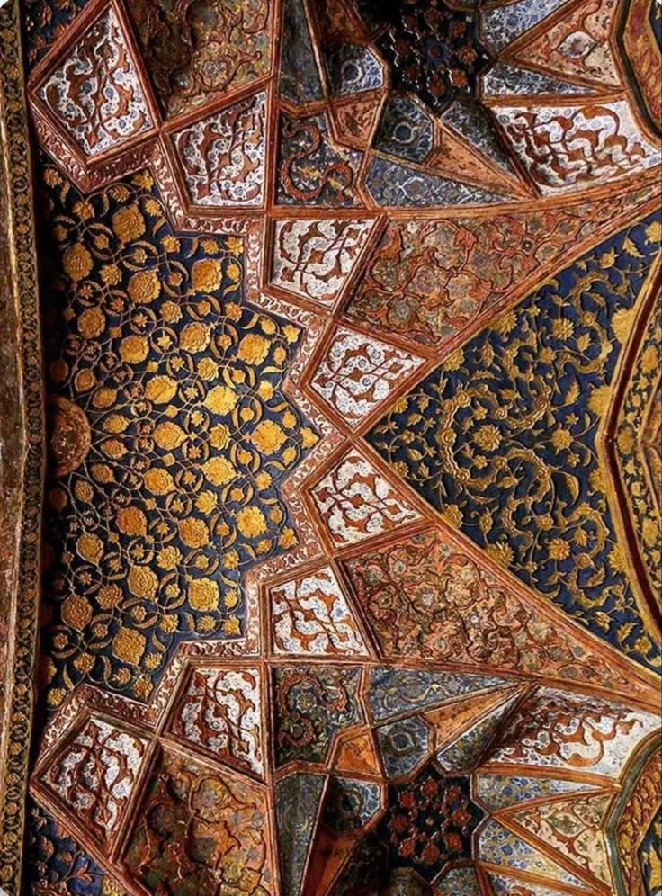 an intricately decorated ceiling in the middle of a building