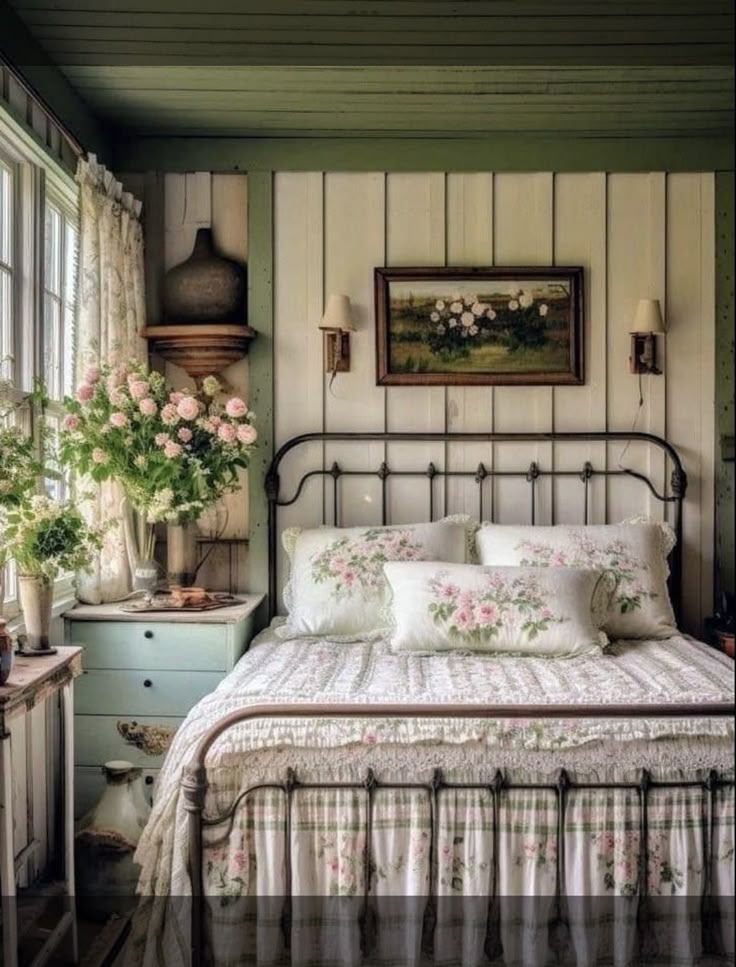 a bed sitting in a bedroom next to a window with flowers on top of it