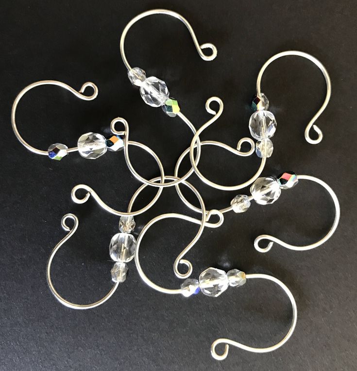 a metal wire sculpture with glass beads on it