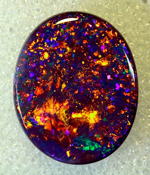 Black Opal is Australia’s national gemstone, and black opal is the rarest and most valuable of its kind, at times selling at prices that rival the best diamonds. The stone must have a rich, black background, but base colors come in all shades of gray, which is why opinions vary on what is a “true” black opal. Found in the Lightning Ridge area in northwestern New South Wales, black opals are natural, solid stones that absorb scattered white light, giving it brilliant spectral colors. Lightning Ridge Black Opal, Pretty Rocks, Tiffany Jewelry, Mineral Stone, Lightning Ridge, Minerals And Gemstones, Rocks And Gems, Precious Gems, Gems And Minerals