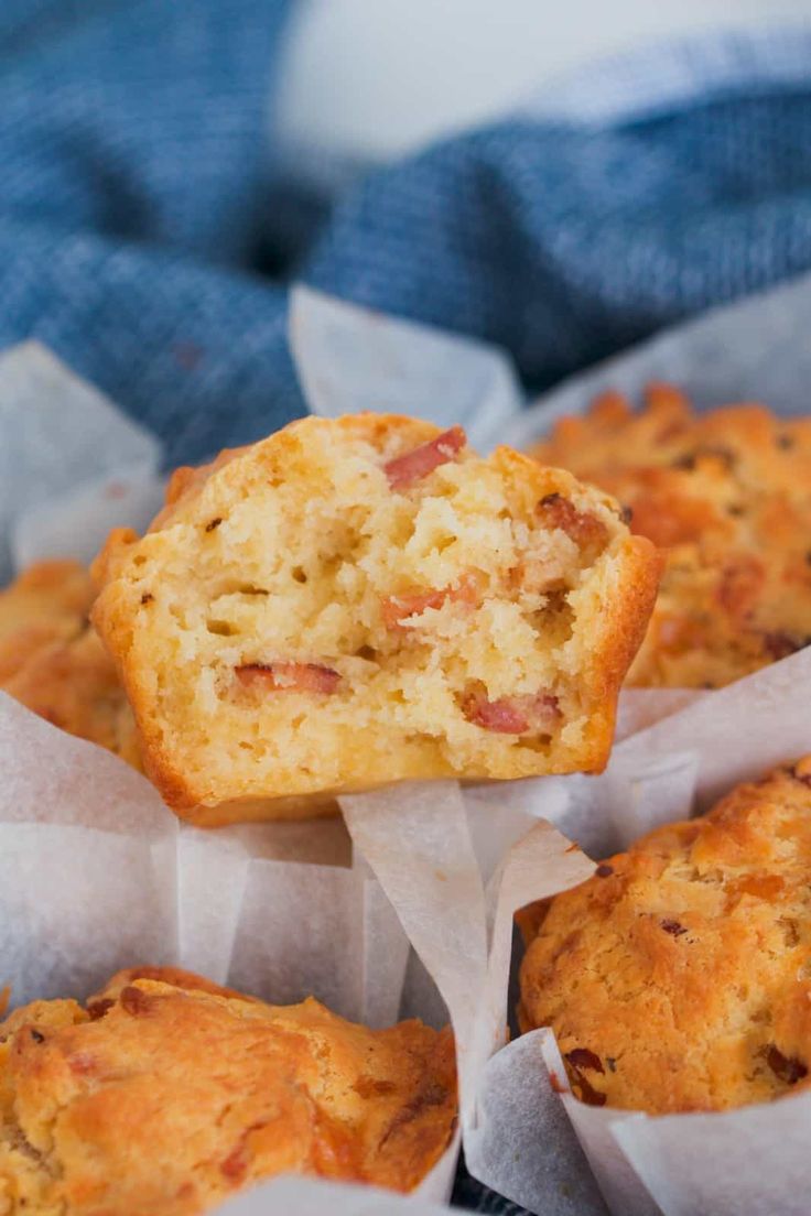 some muffins that are sitting on top of each other in paper wrappers