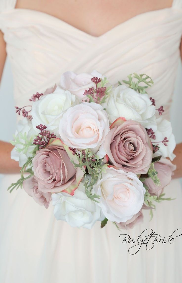 a bridal holding a bouquet of pink and white flowers