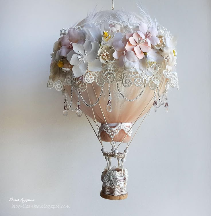 a hot air balloon decorated with flowers and pearls