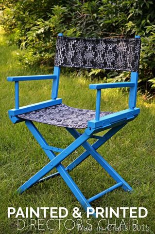 a blue painted and printed director's chair sitting in the grass