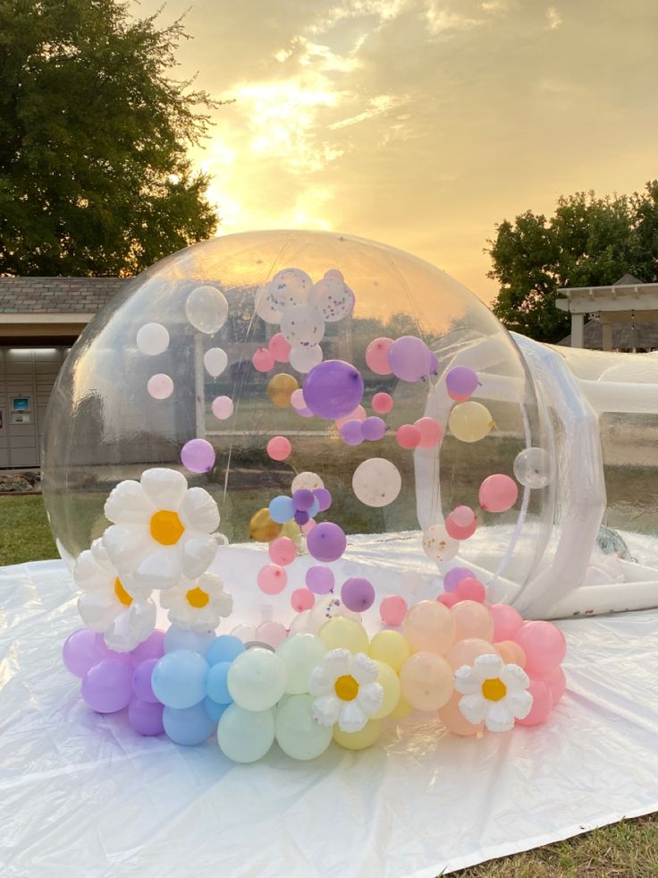 an inflatable bubble filled with balloons and flowers