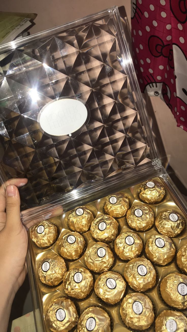 a person holding a box full of chocolates