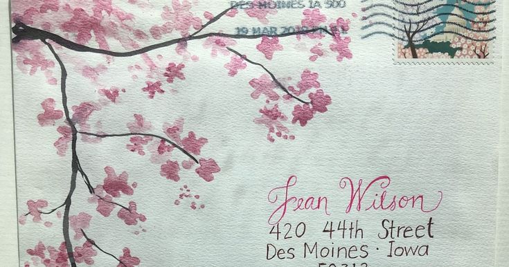 a close up of a mail envelope with pink flowers on the front and back of it