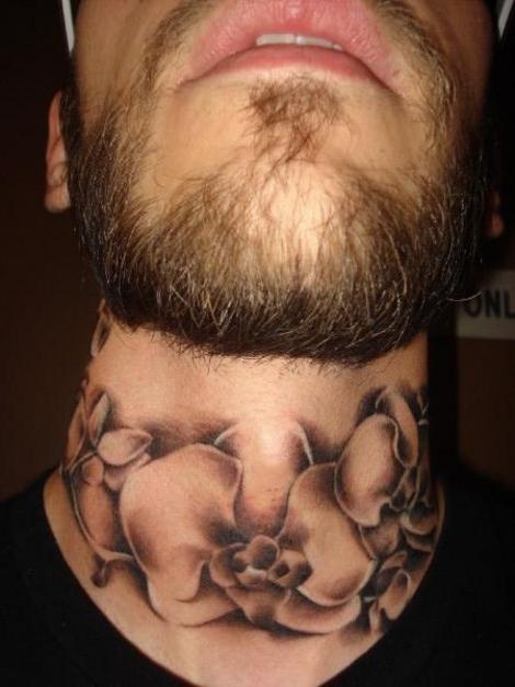 a man with a neck tattoo that has flowers on his chest and the bottom part of his neck