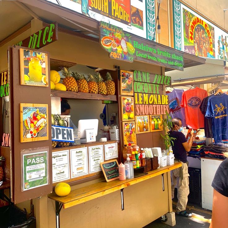 a person standing in front of a food stand