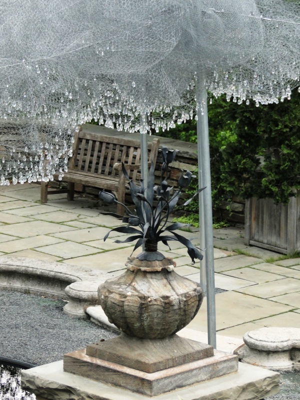 an umbrella that is sitting in the middle of a fountain with icicles on it