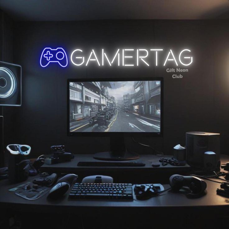 a gaming room with a large monitor, keyboard and speakers on the desk in front of it