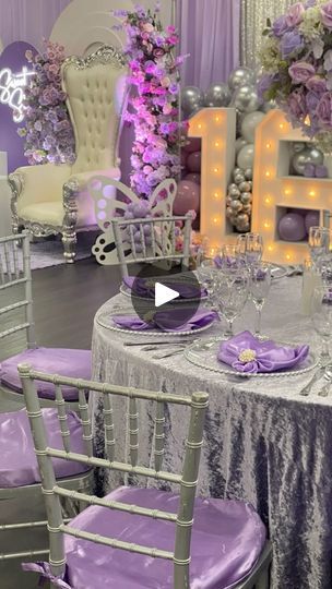 the table is set with purple and silver decorations