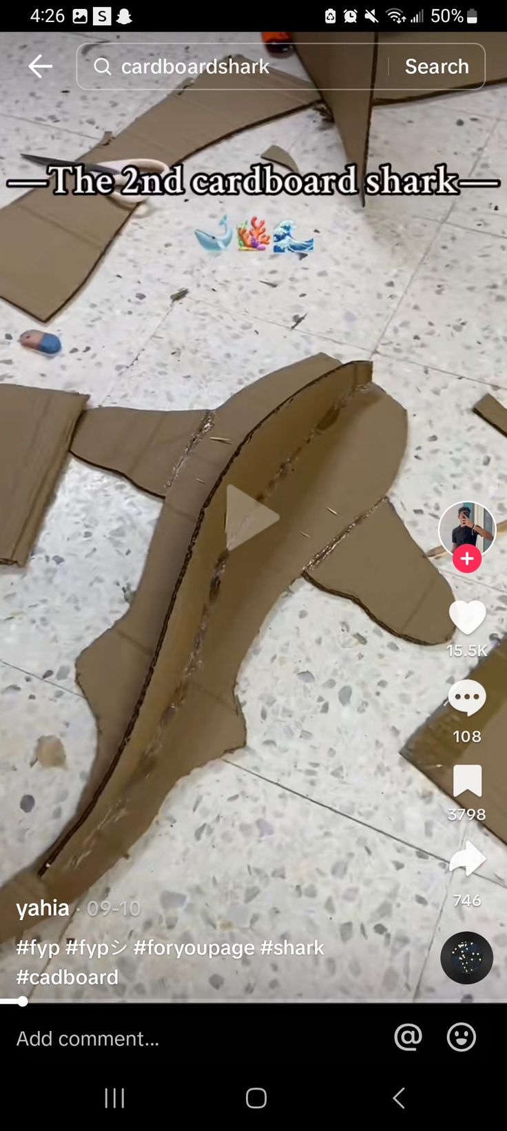 the cardboard shark is cut into pieces and placed on the floor with other items to make it