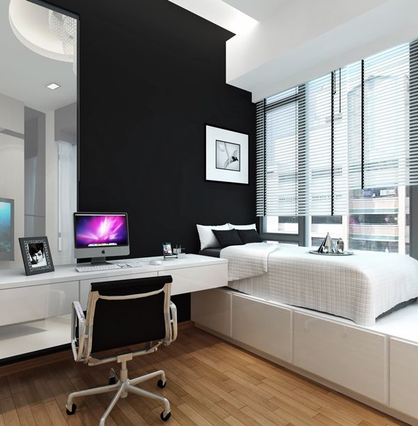 a bedroom with two beds and a desk in front of the bed is black and white